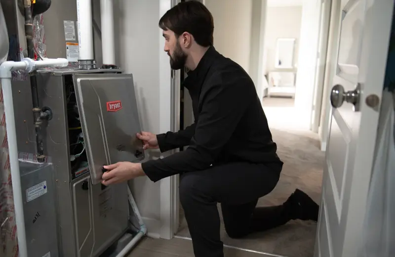 Technician servicing a Bryant gas furnace