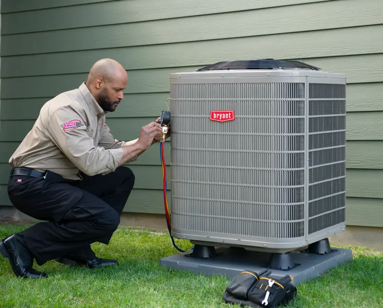 Technician testing a Bryant heat pump