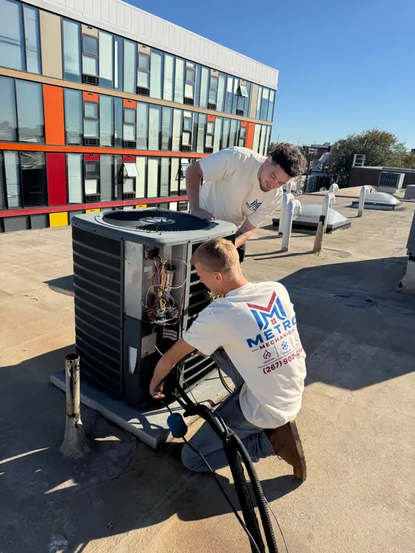 Metro Mechanical tech on a rooftop HVAC job in the city